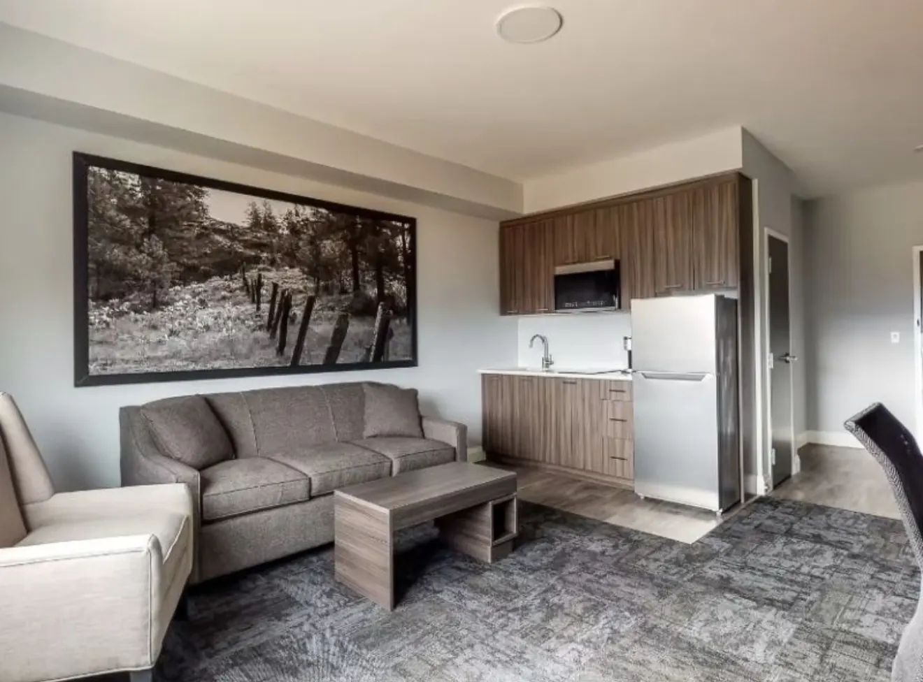 Suite kitchenette with full-size fridge, microwave and sink at Park Inn by Radisson Osoyoos